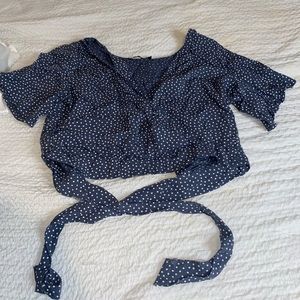 Abercrombie light navy blue and white polka dot top with semi open back.